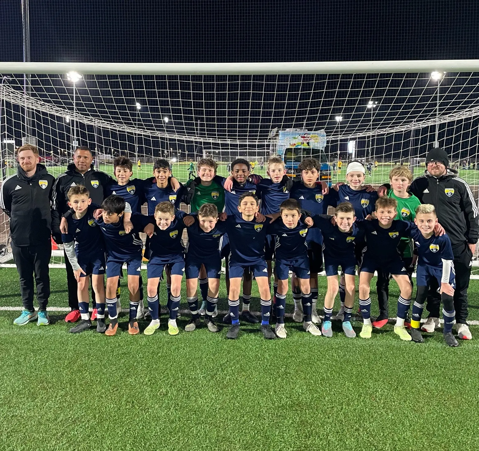 Daylen Hammon in navy Colorado ODP kit with white headband in team photo with coaches, 2024