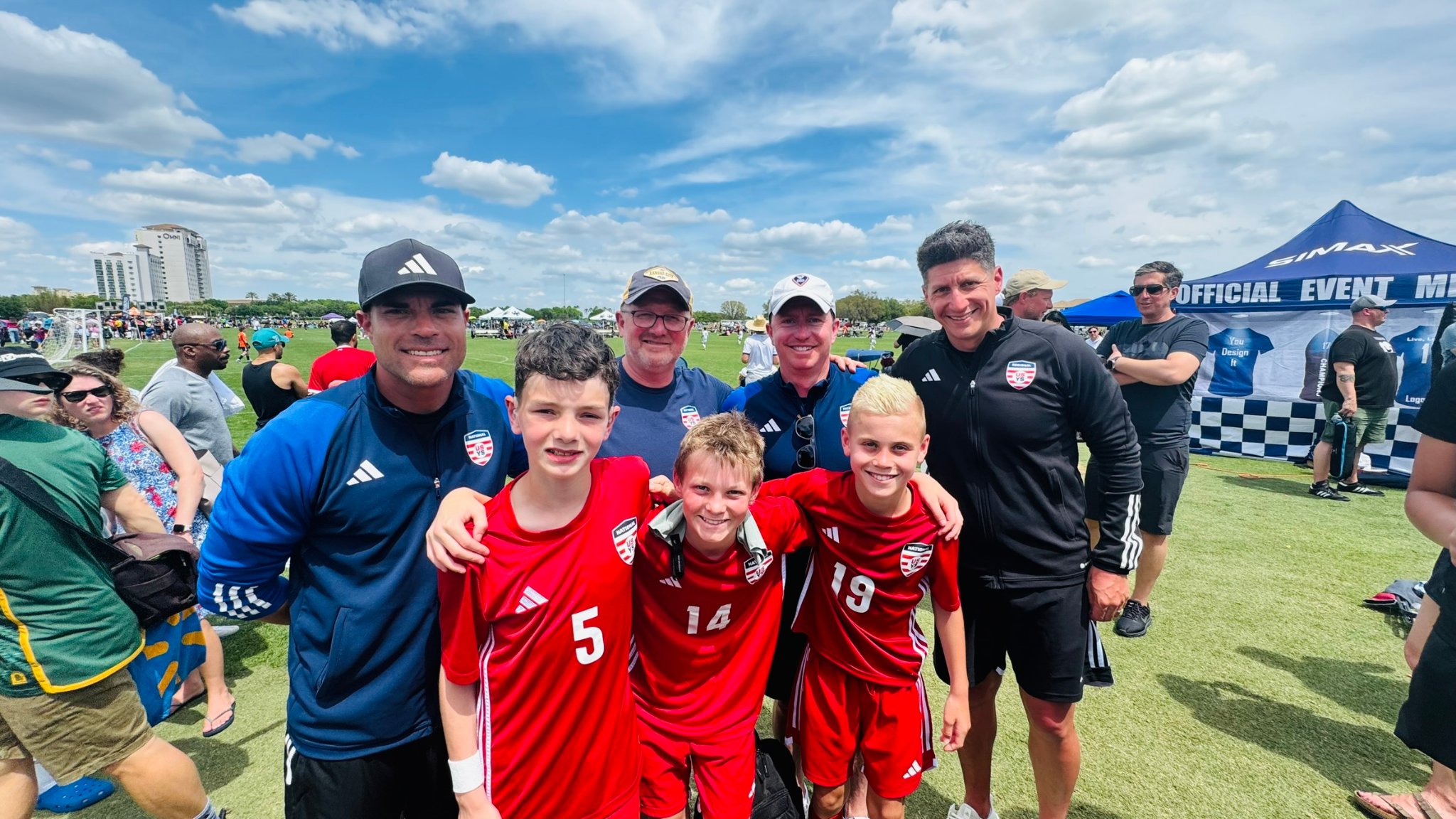 Daylen Hammon #5 in ODP red kit with coaches and teammates at Easter International Cup in Orlando