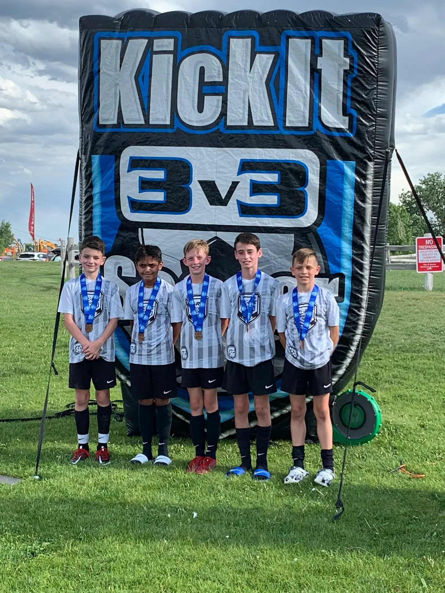 Real Colorado Academy team in white kits with silver medals at Colorado Rapids Youth Soccer Tournament Series Champions adidas backdrop