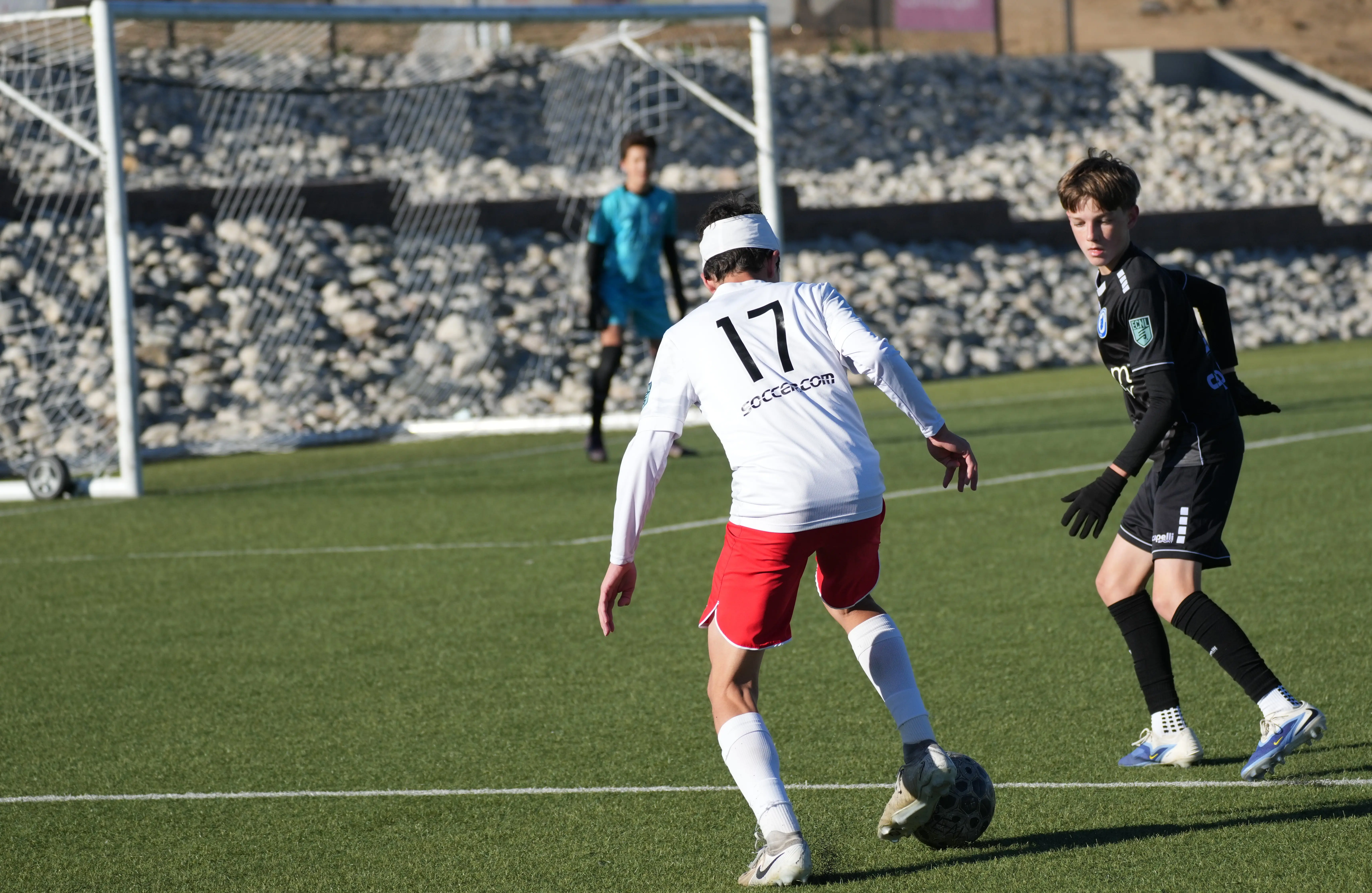 Daylen Hammon in white Real Colorado kit #17 with white headband shielding ball from opponent in black kit, league match October 2025
