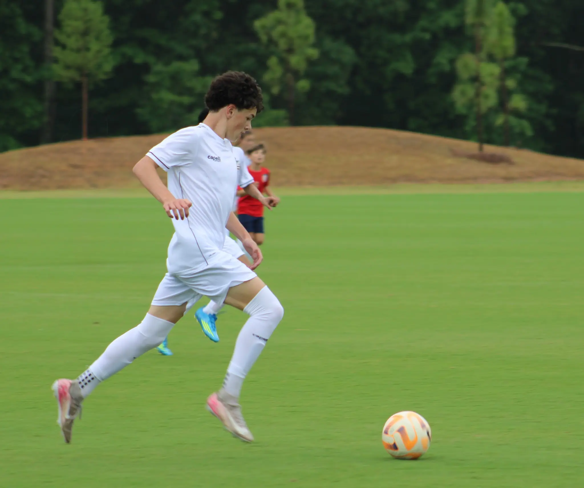Daylen Hammon in white Capelli kit chasing the ball at US Soccer National Training Center, May 2026